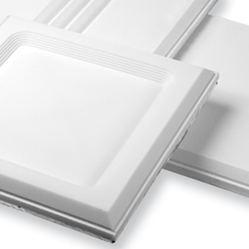 Two white square ceiling tiles with a subtle textured border stacked on a white surface.