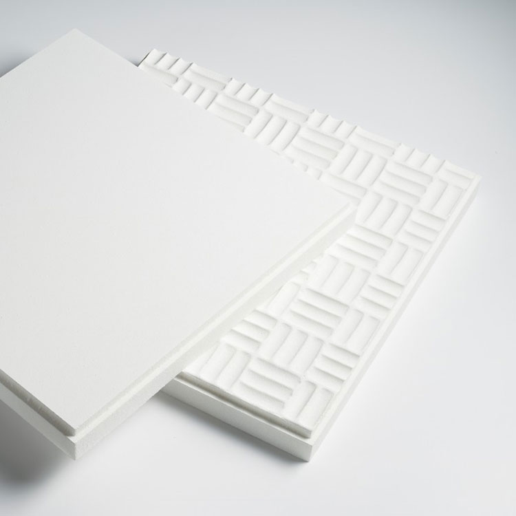 Two white acoustic foam panels, one with a smooth surface and the other with a geometric pattern of raised rectangular shapes.