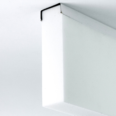 Close-up of a white rectangular linear noise absorber mounted at a corner.