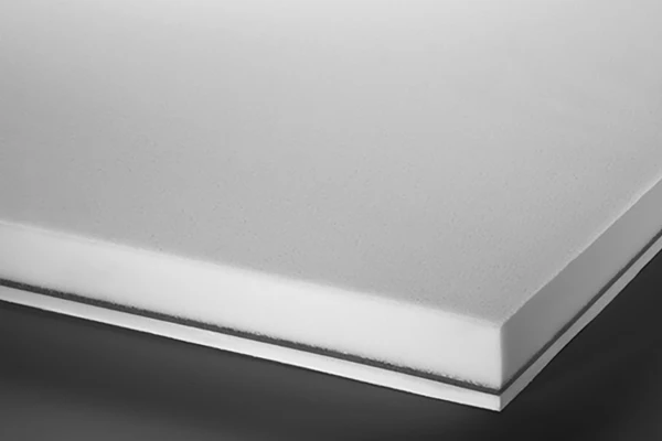 Close-up of a white composite panel with a smooth surface and layered edges.