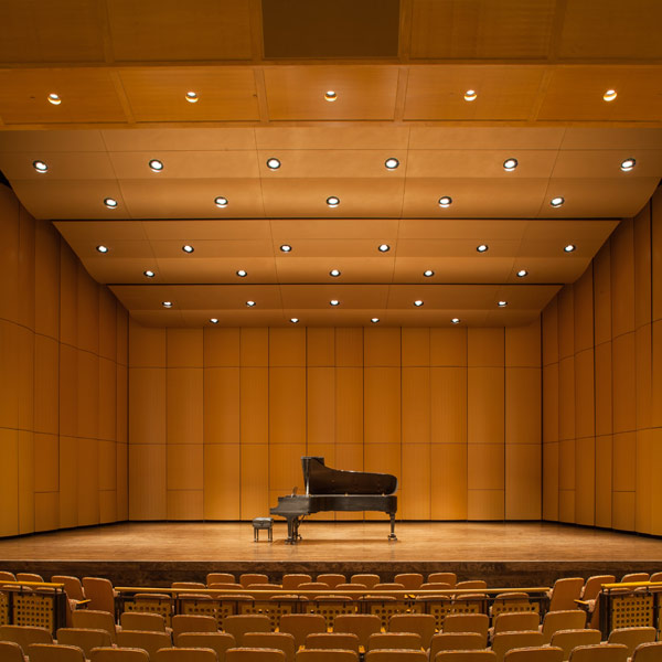 Opus II Concert Acoustic Shell by StageRight, with center-supported towers and integrated reflective ceiling cloud panels on a performance stage.