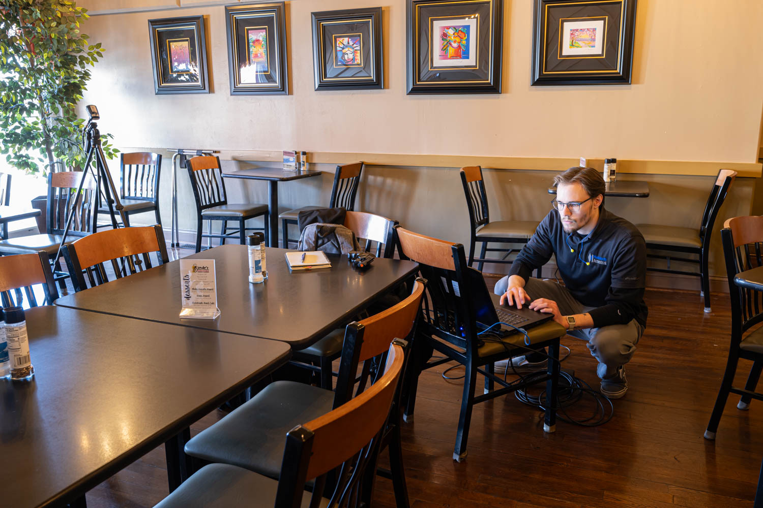 Overhead view of a project team around a table reviewing laptops, notebooks, and documents.