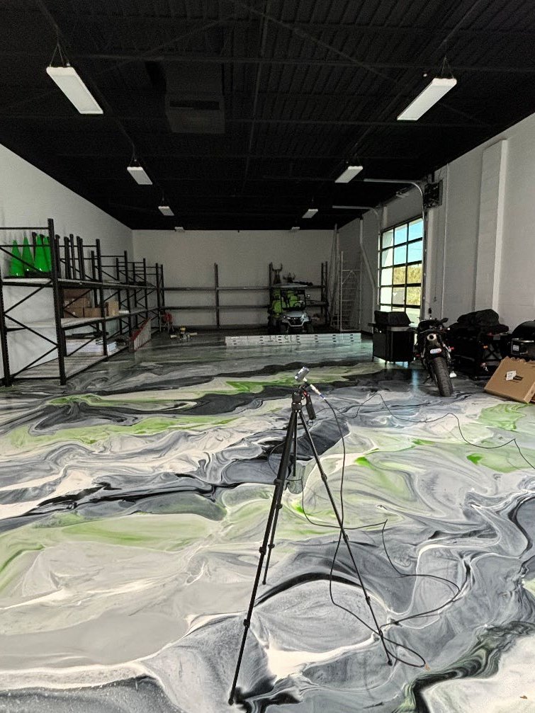 Unoccupied call center space at Puff Cannabis headquarters in Troy, Michigan, with a measurement microphone on a tripod during the reverberation study