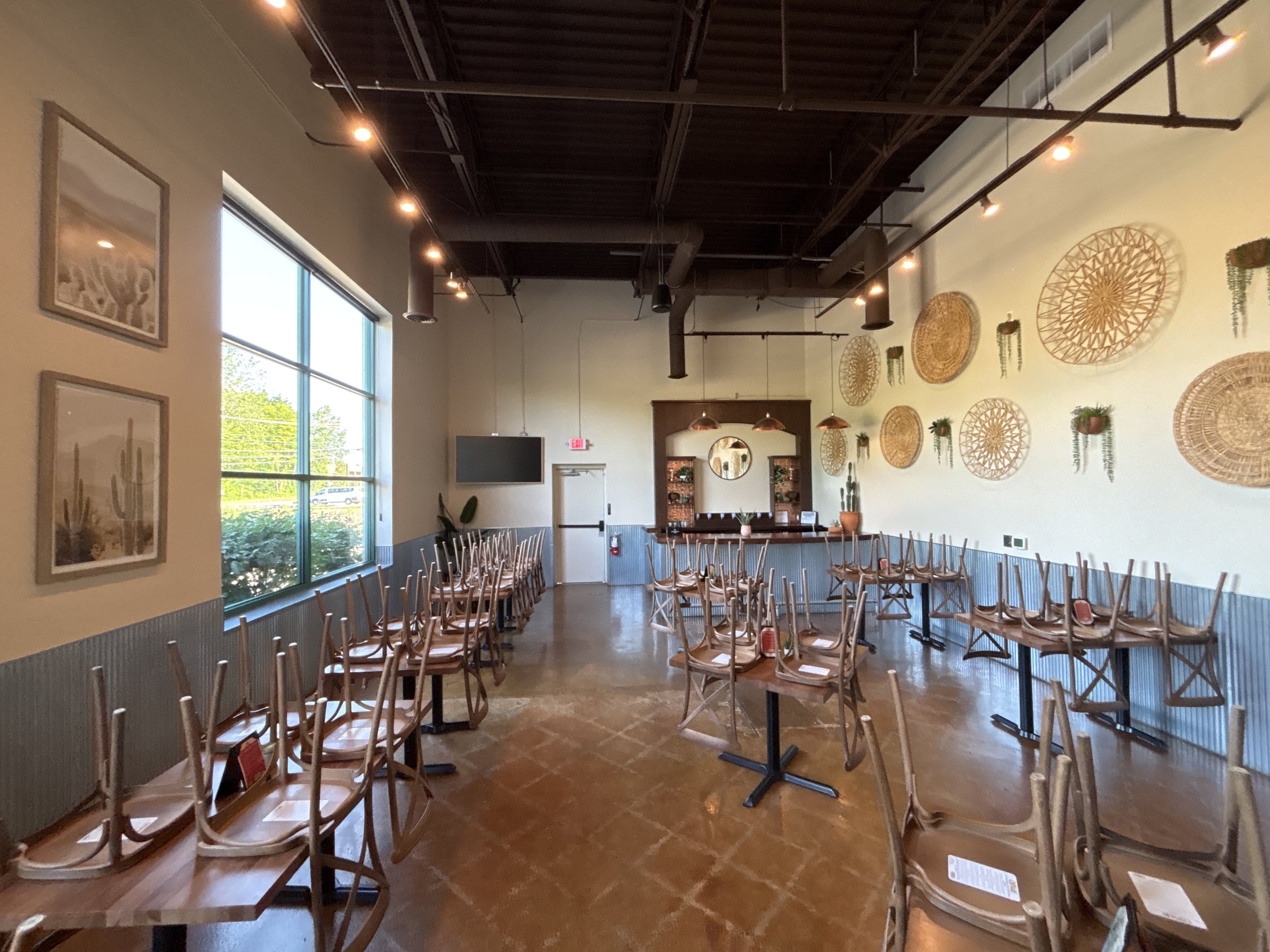 Dining room of a Shelby Township restaurant under an exposed metal roof deck, photographed during Memtech Acoustics' reverberation study