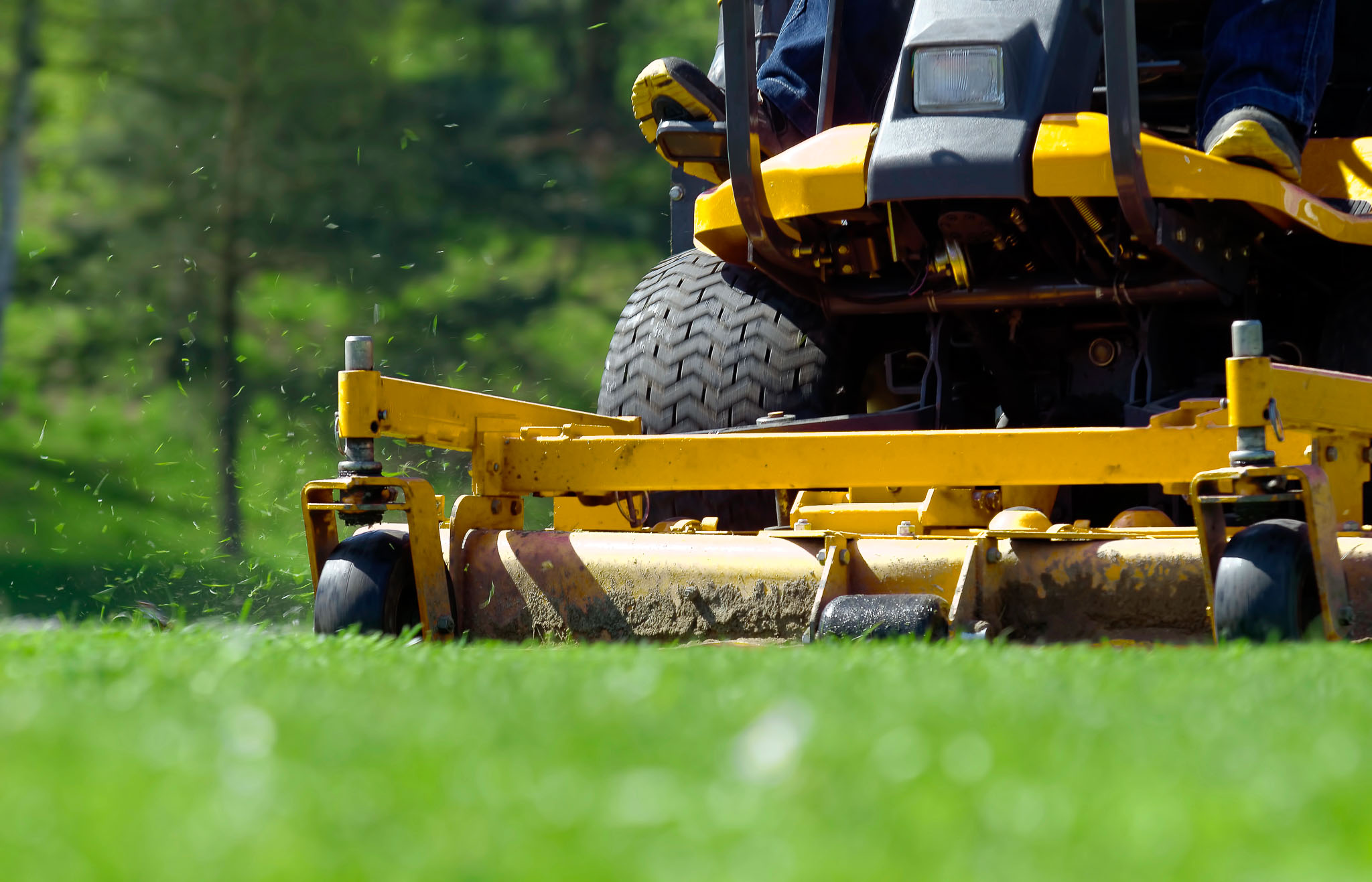 Low angle shot of yellow ride-on lawnmower