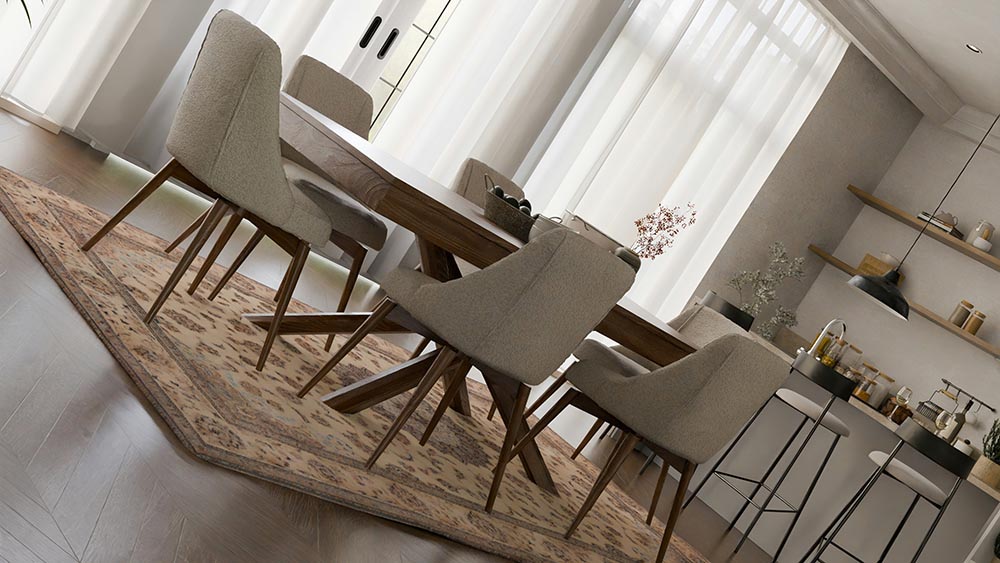 Modern dining room with beige upholstered chairs around a wooden table on a patterned area rug, adjacent to a kitchen island with bar stools.