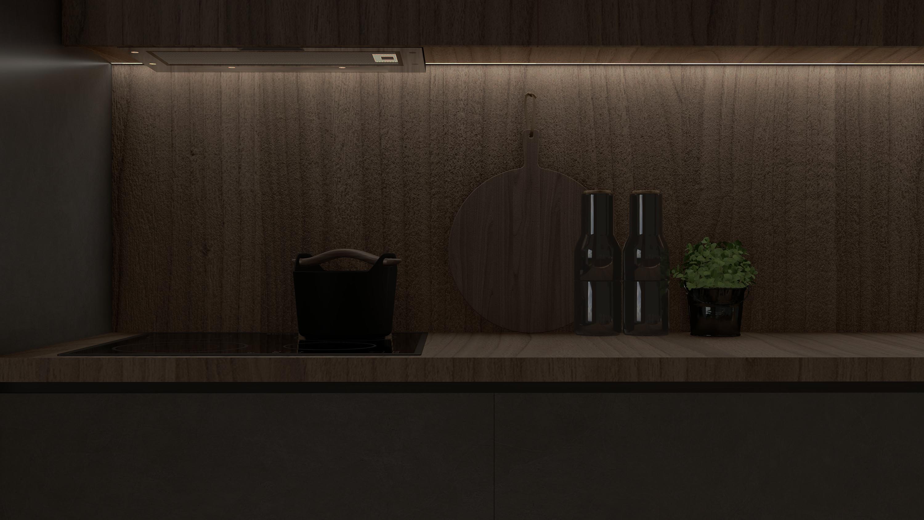 Modern kitchen countertop with induction cooktop, black pot, wooden cutting board, two dark bottles, and a small potted plant under warm LED strip lighting.