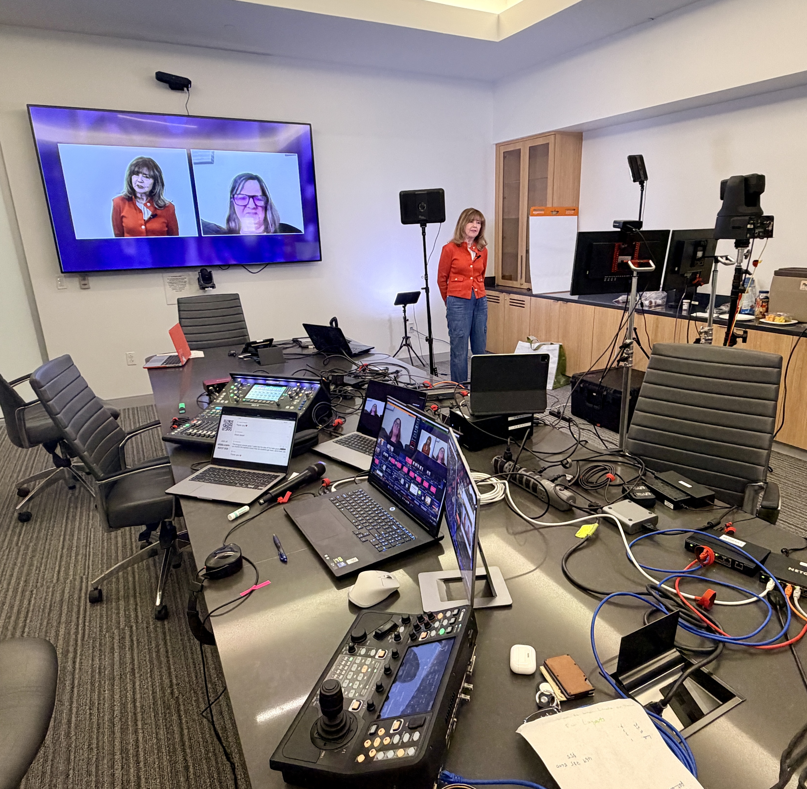 Hybrid webcast setup with remote presenters on screen and equipment