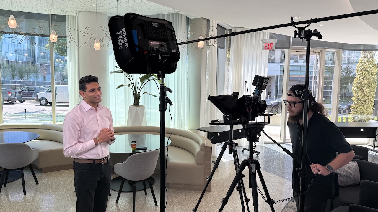 On-location corporate video interview with lighting and camera operator