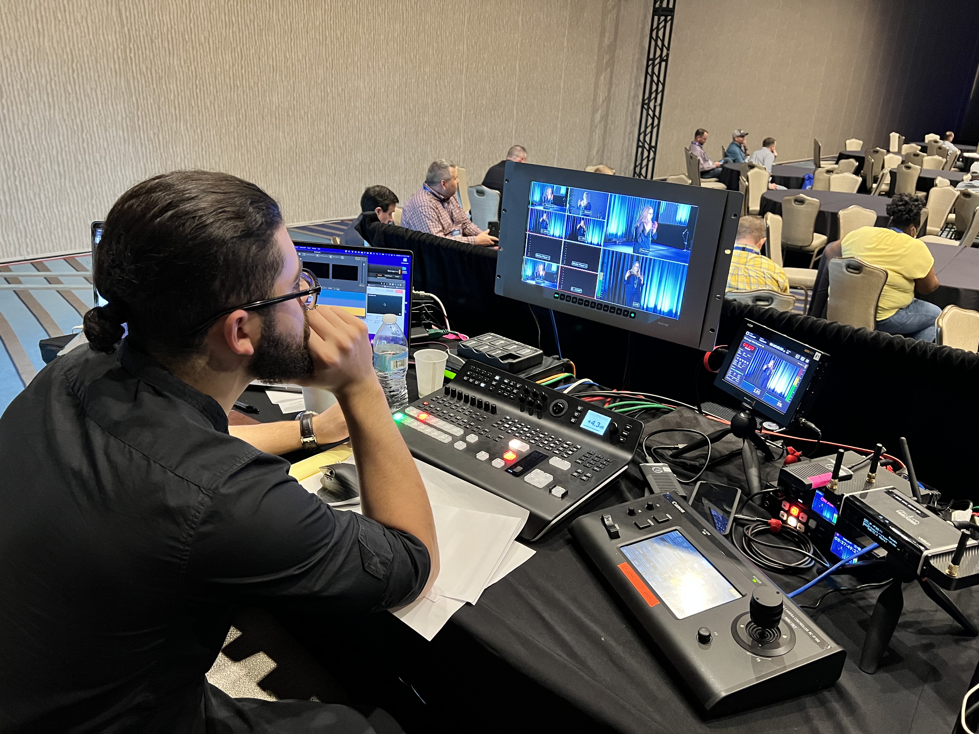 Producer operating a Blackmagic ATEM switcher and multiview during a conference breakout session
