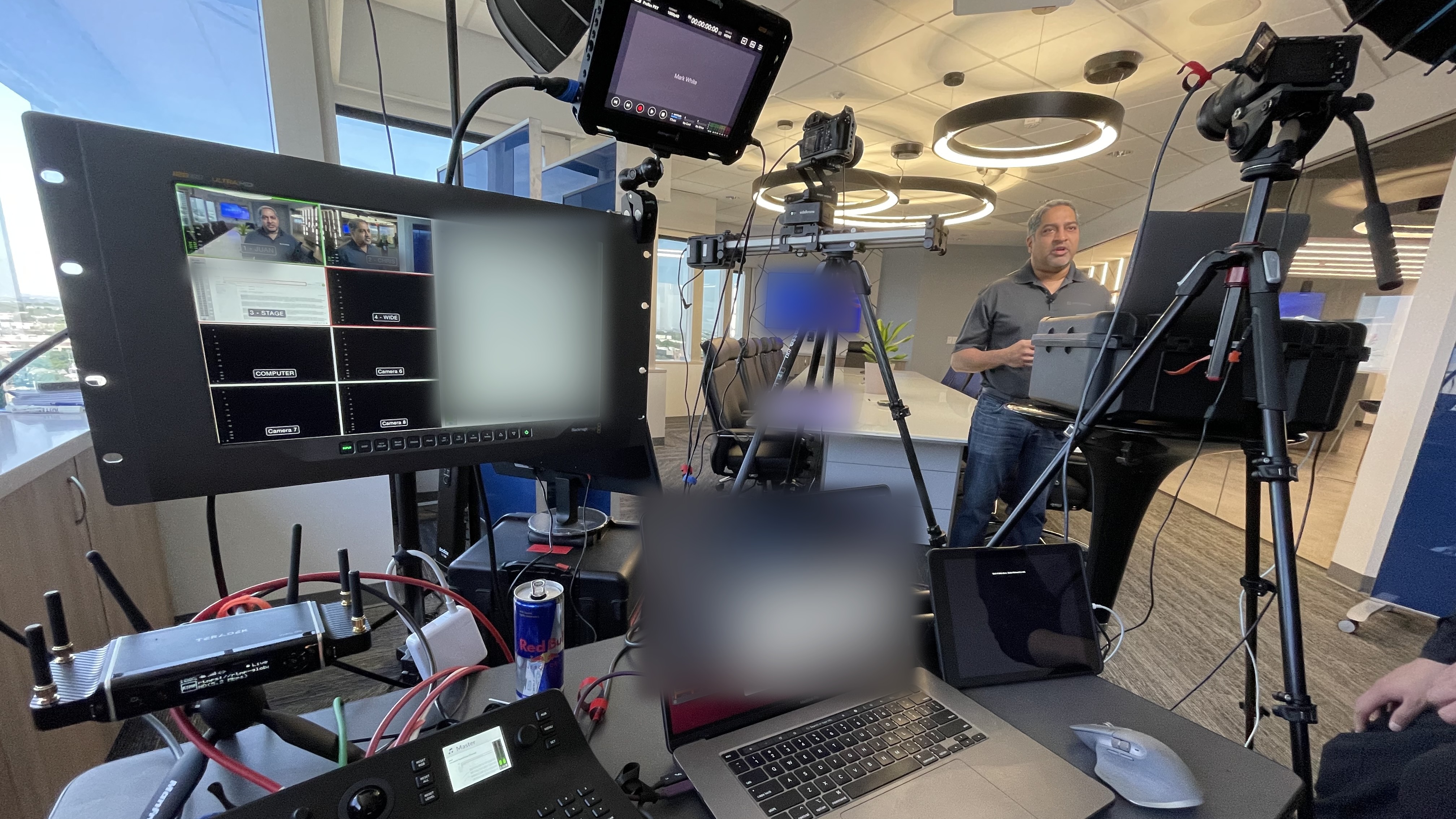 Production desk with a multiview monitor, switcher and laptop feeding a corporate webinar