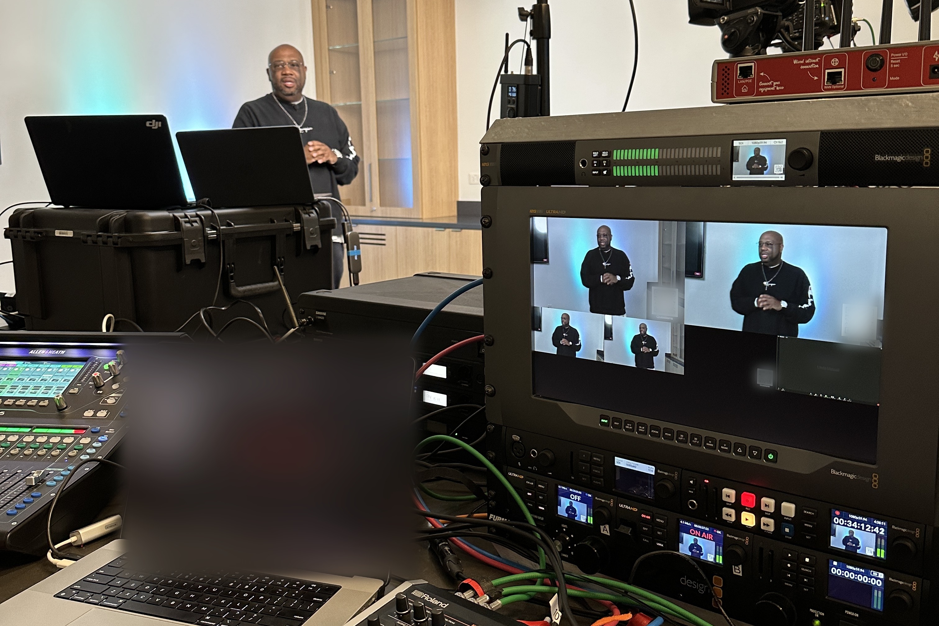 Live production rack with switcher, multiview and audio mixer producing a remote member webinar