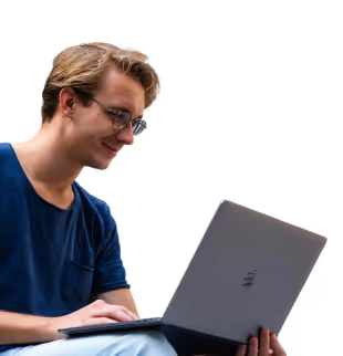 Smiling developer working on a laptop while debugging Python code, with Wald.ai providing DLP for AI and secure access to ChatGPT to keep sensitive data safe