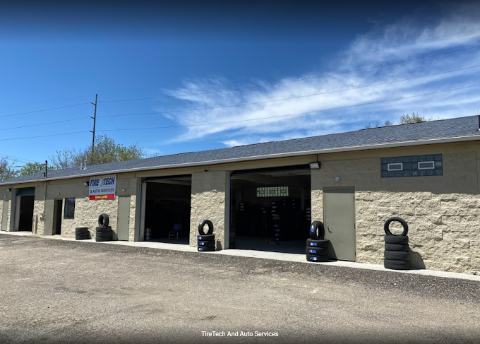 Exterior view of TireTech auto service building, featuring tire displays and clear blue skies.