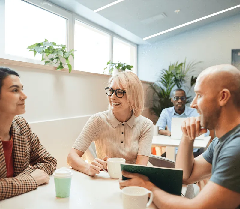 A group of people sitting around a table talking.