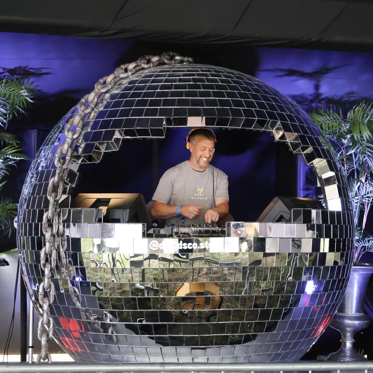 A DJ playing in a disco ball on Beat Bunker festival.