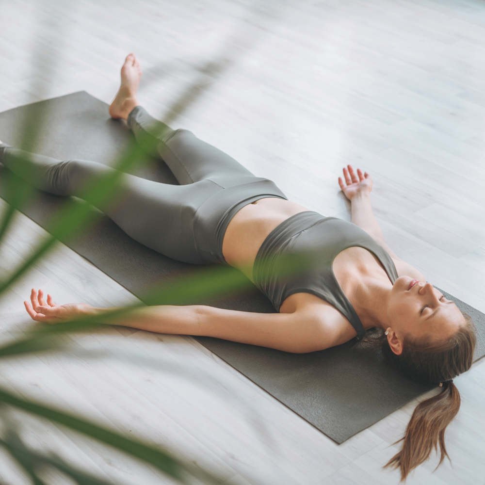 Woman laying on yoga mat relax