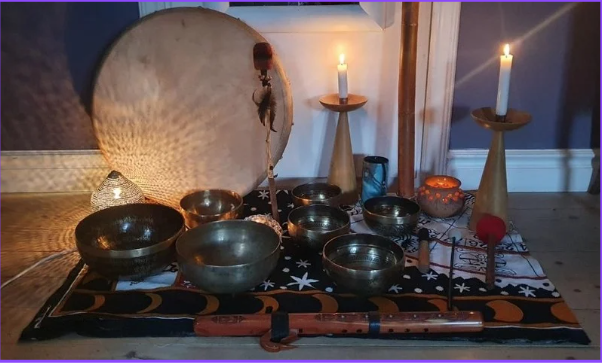 Focused woman practicing Tai Chi with the sun shining through trees in a blurry background