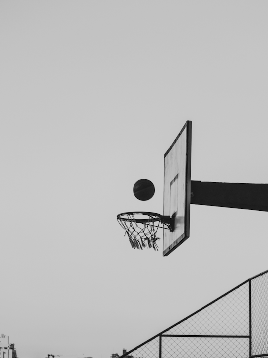 Basketball hoop against grey sky
