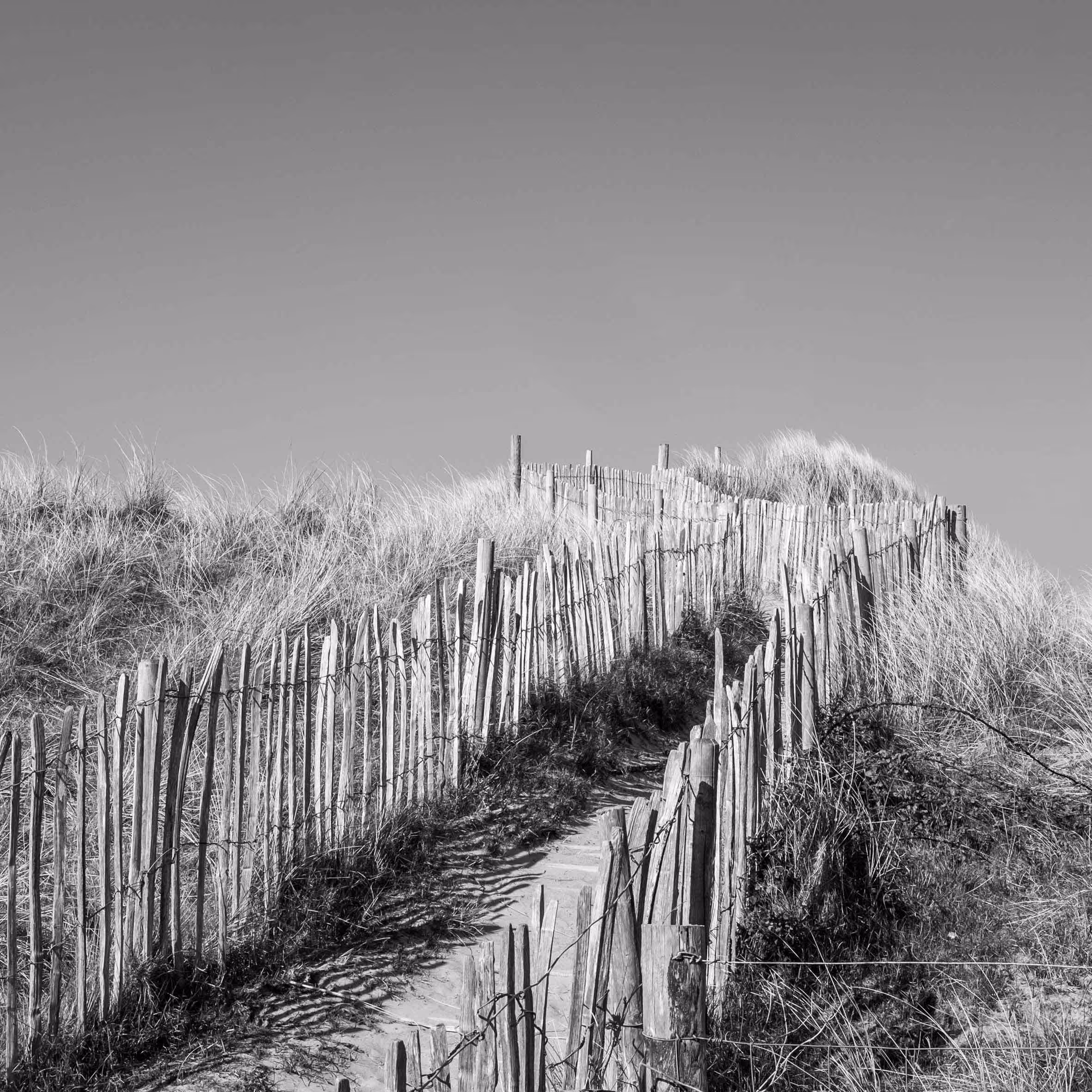 A black and white photo of sand dunes in Wales