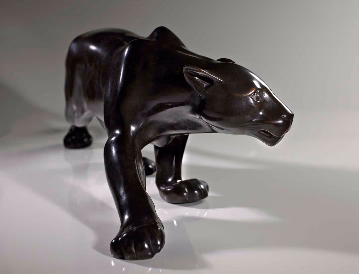 A photo of a hand-carved wooden jaguar figurine
