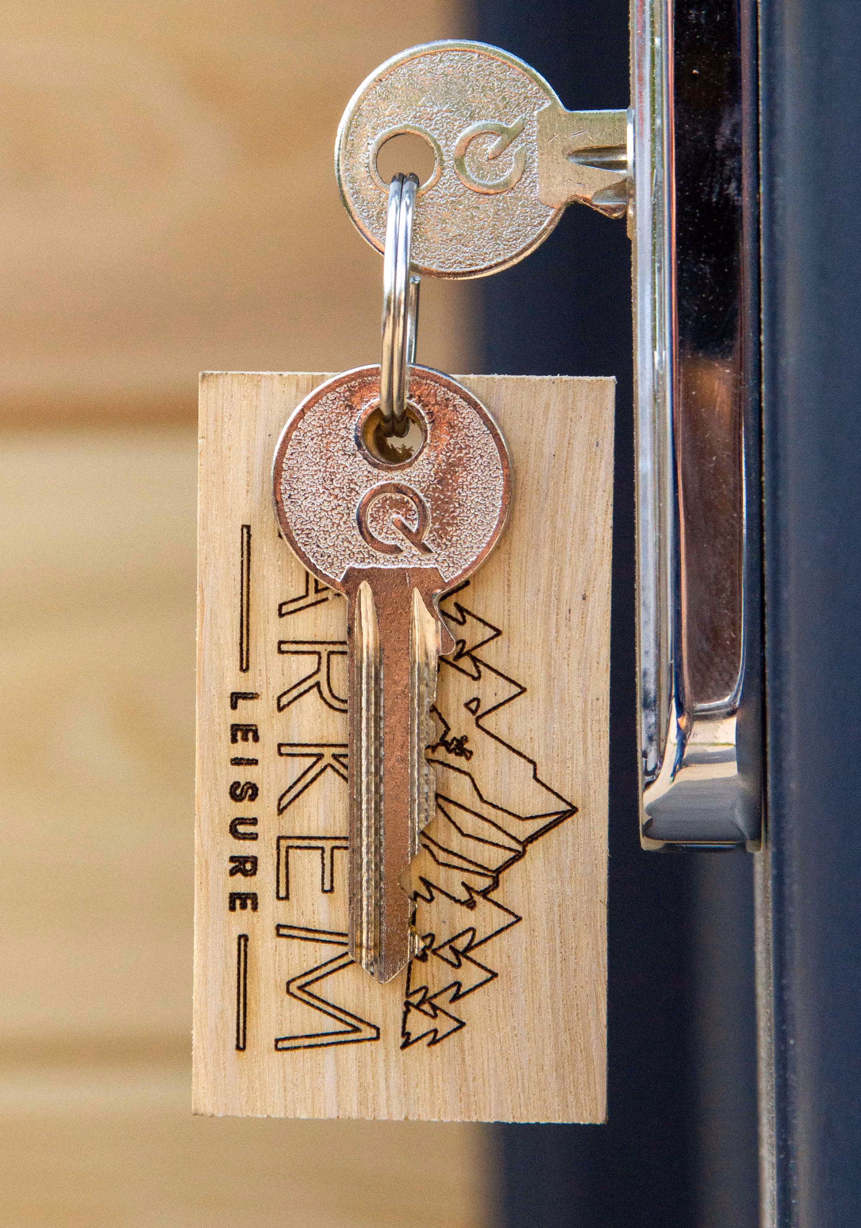 A photo of the key for a portable toilet block - with branded key chain