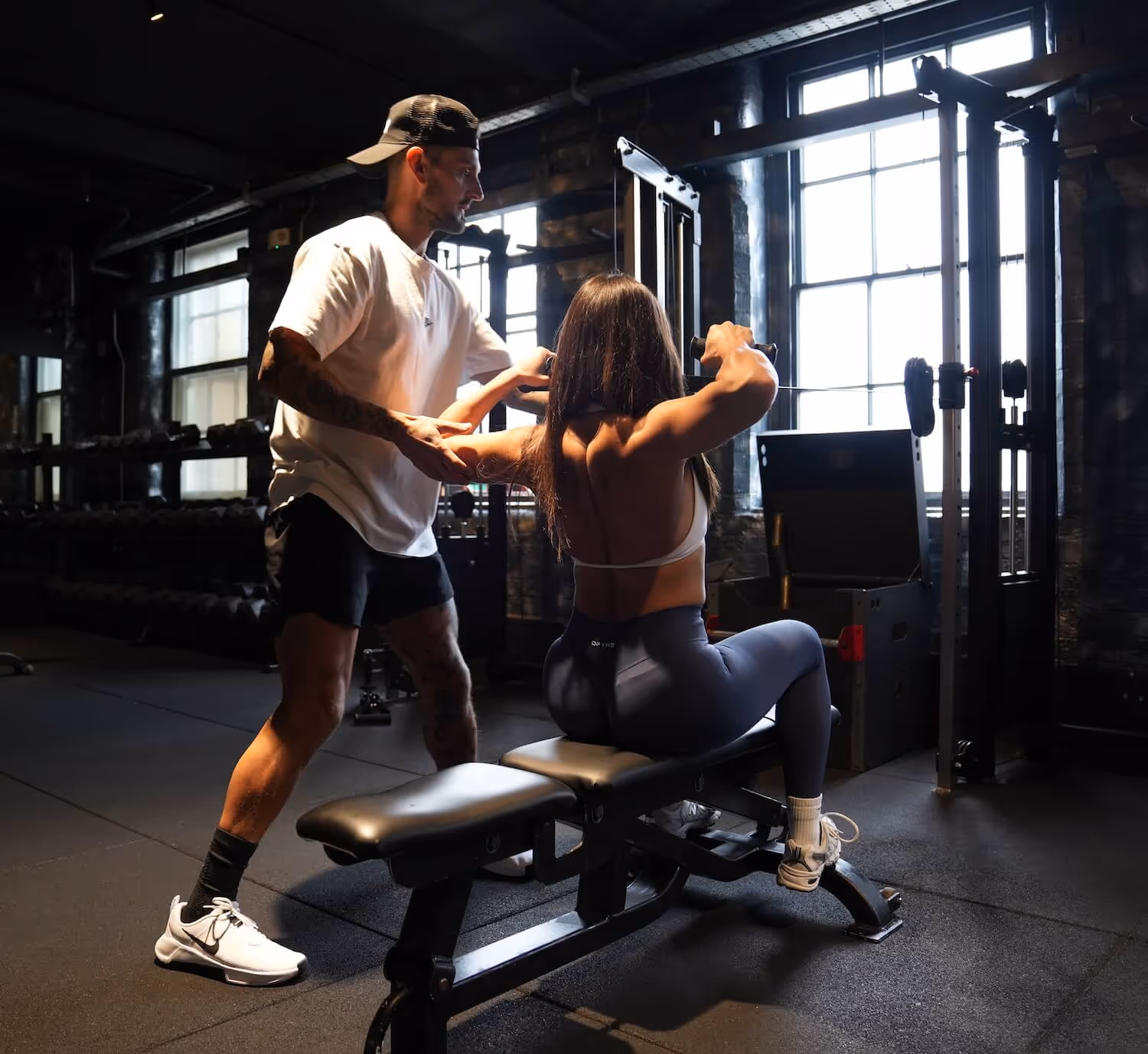 Female client training with personal coach at ONE DZ Gym Derby during a strength session