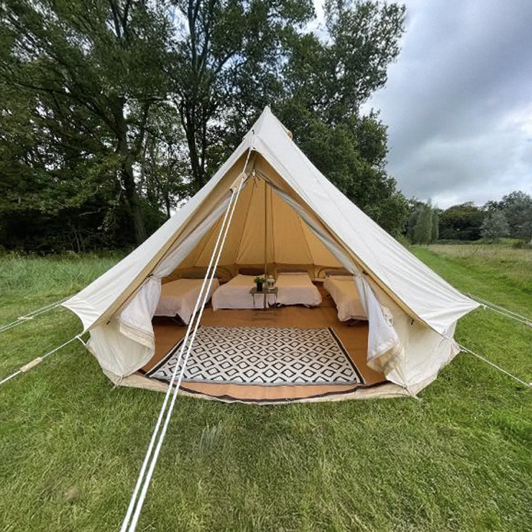 A white tent in a garden.