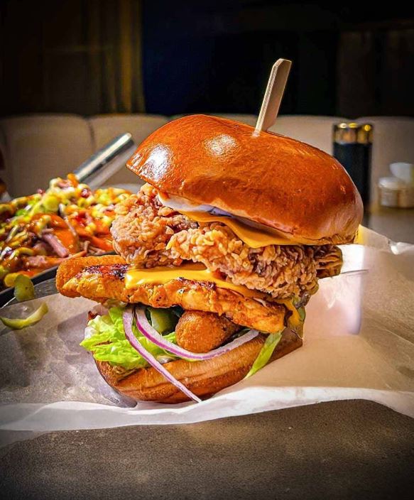 Chicken burger stacked with crispy fillet in a toasted bun