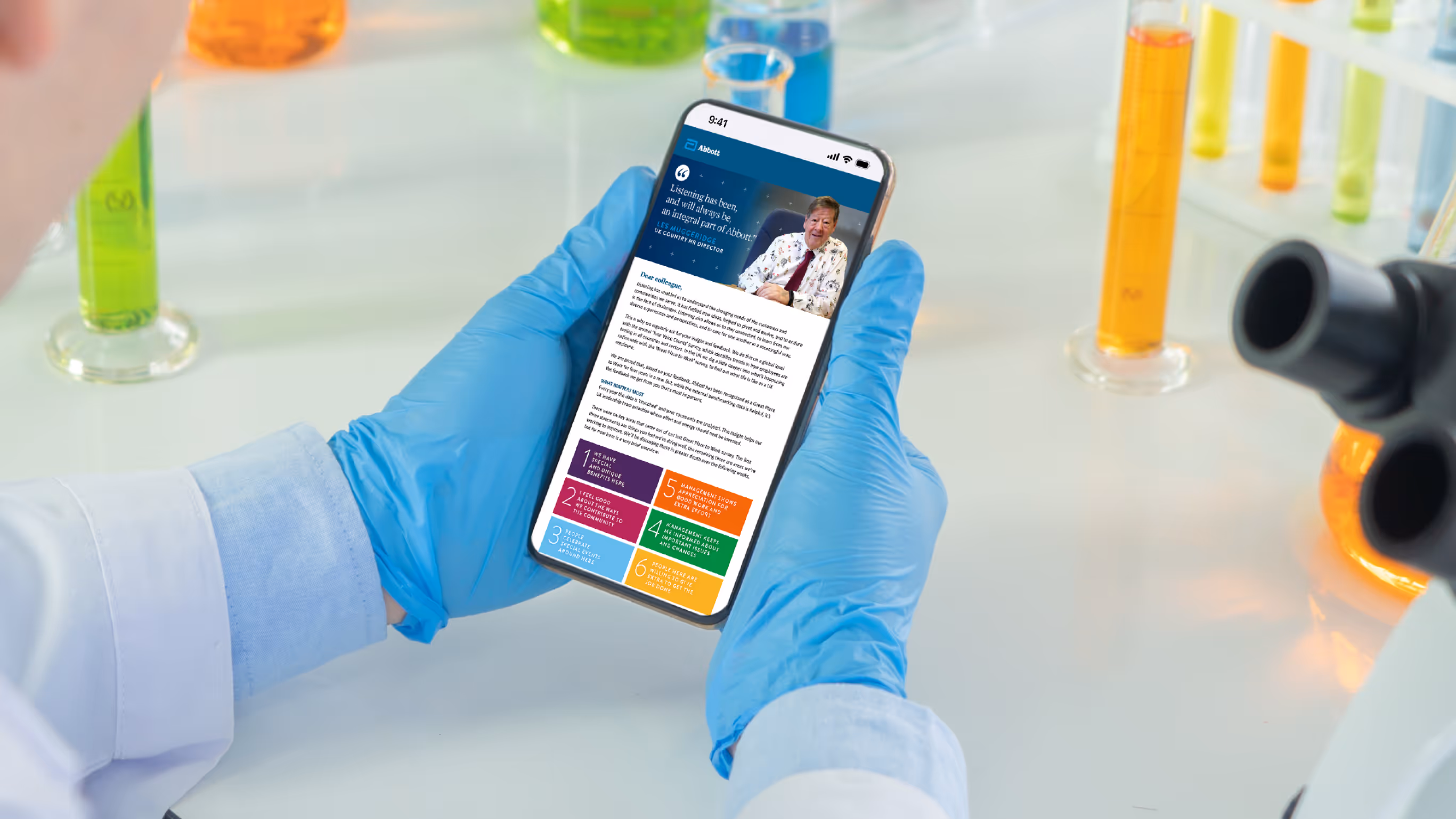 Gloved hands holding smartphone with scientific content in lab setting