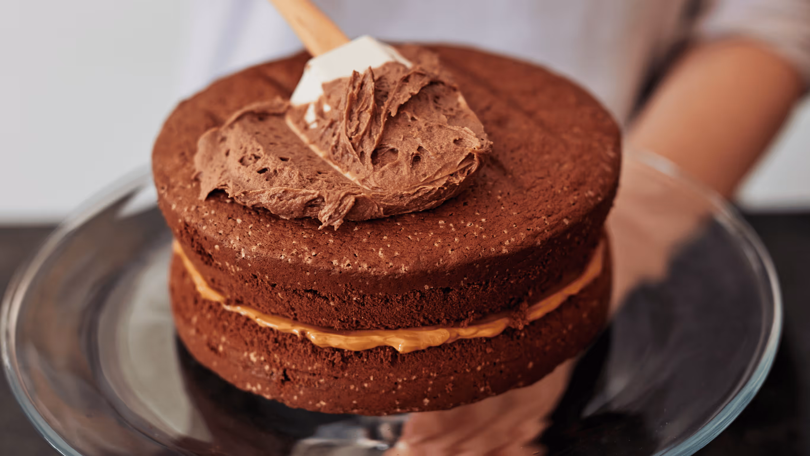 Decadent chocolate cake with caramel filling and swirled chocolate frosting