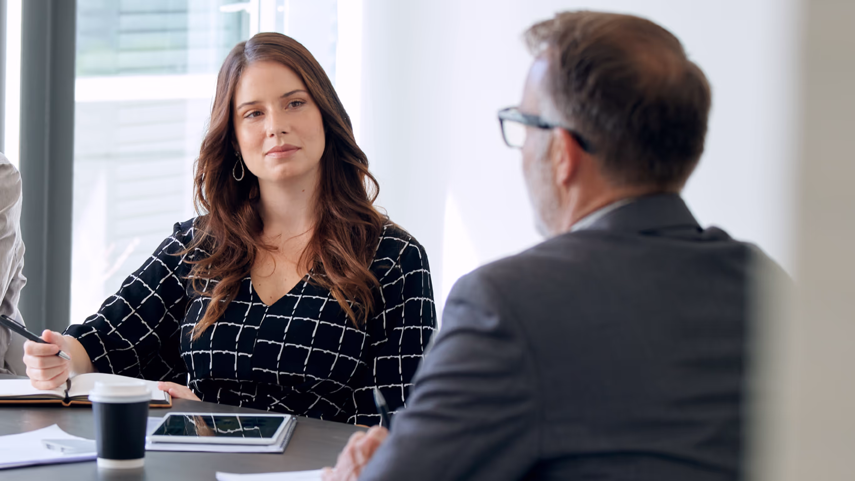 Professional meeting between a woman and a man in an office setting