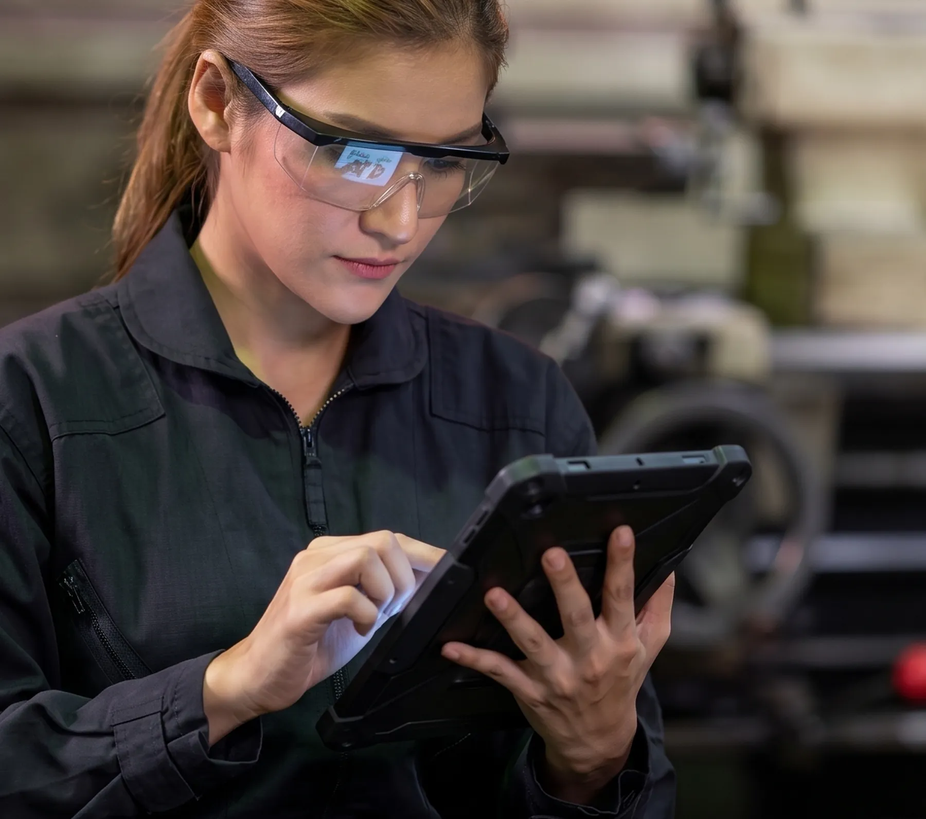Technician checking production status on a rugged tablet