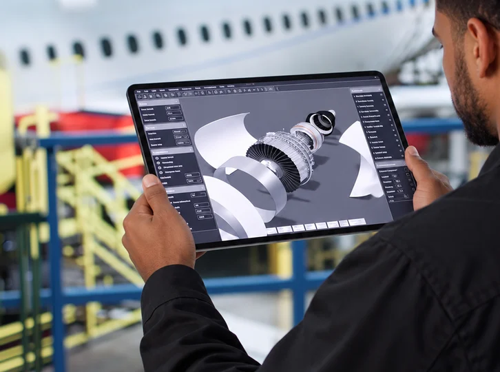 Engineer inspecting a 3D component model on a tablet