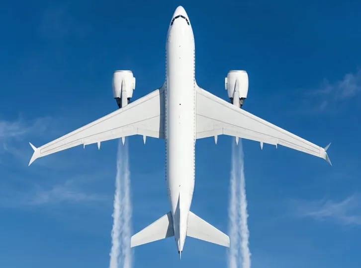 Aircraft climbing through a clear blue sky