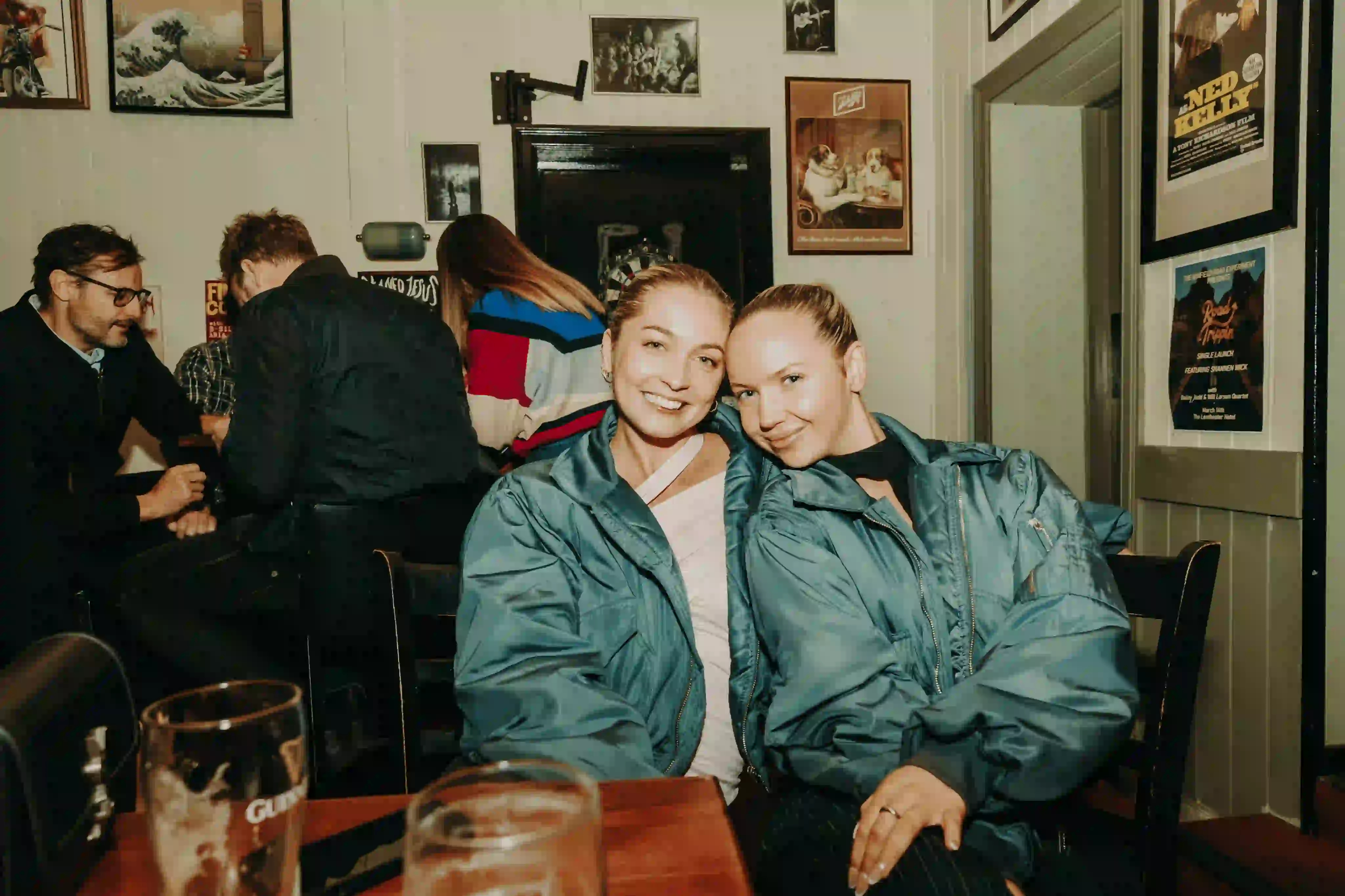 Two women sitting next to each other at a table.