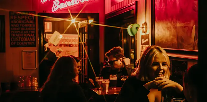 A group of people sitting at a table in a restaurant.