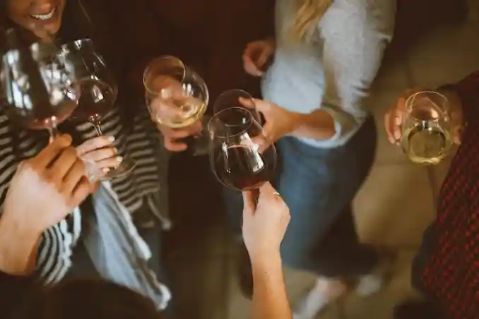 A group of people toasting with wine glasses.