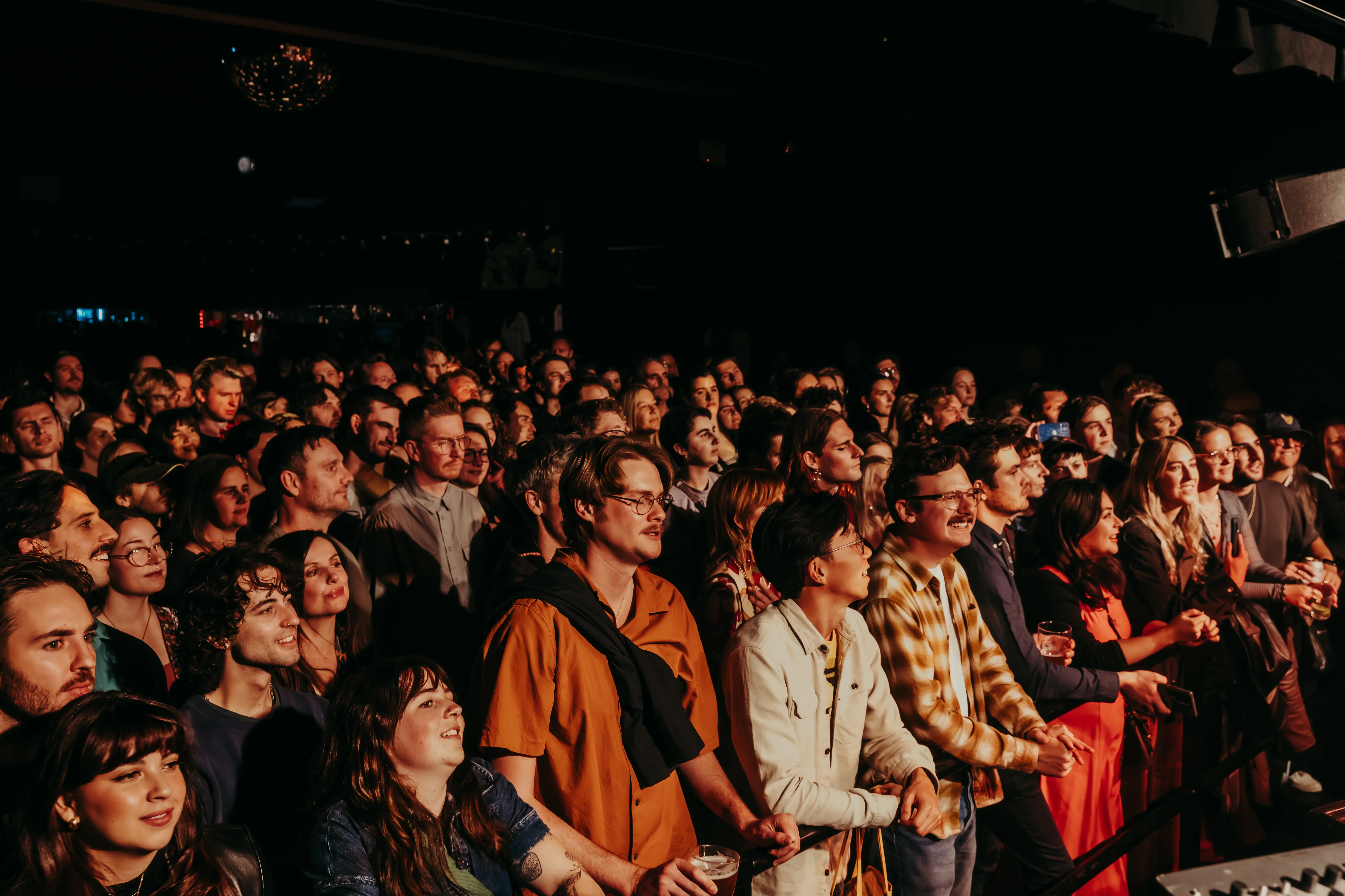 A large group of people sitting in a room.