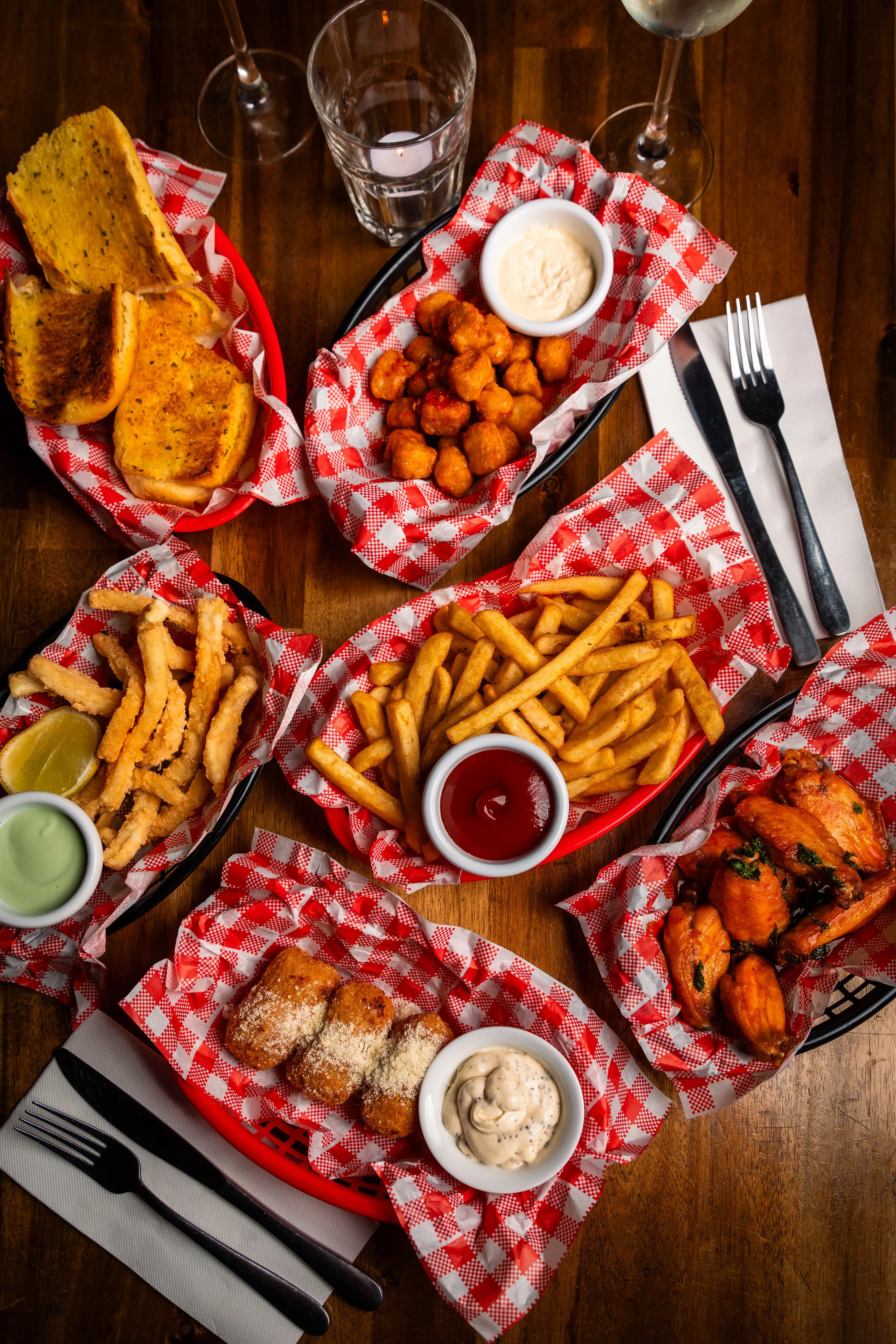 A wooden table topped with plates of food.