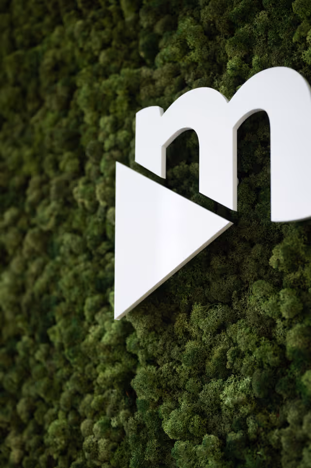 movingimage favicon on a vegetal green wall