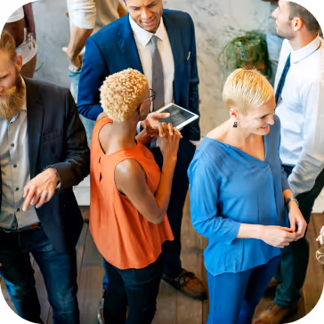 A group of people wearing suits standing and talking in a networking event