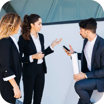 3 colleagues talking and wearing suits