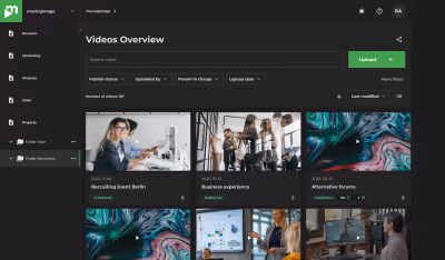 Dashboard screen showing a videos overview with thumbnails and details in a dark theme interface.
