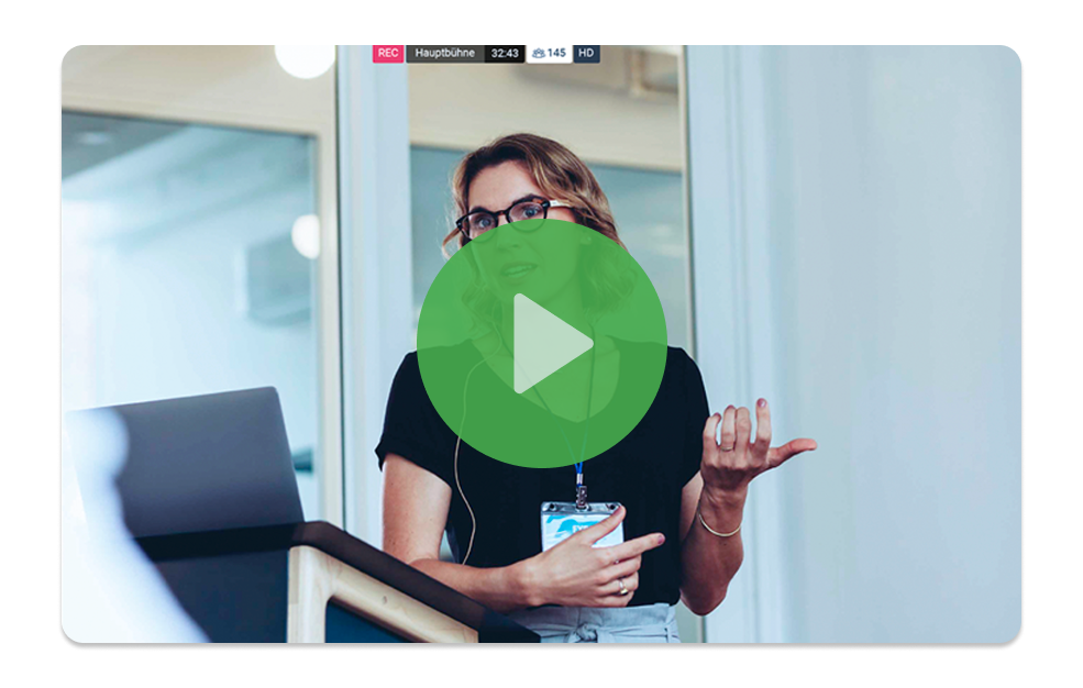 Video thumbnail of a woman presenting at a podium during a live-recorded event, with viewer count and HD indicators shown.
