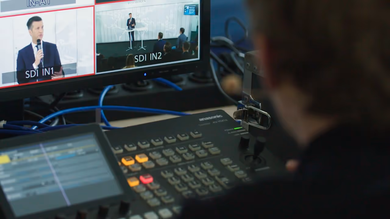A film crew operating a professional video camera during a corporate livestreaming production.