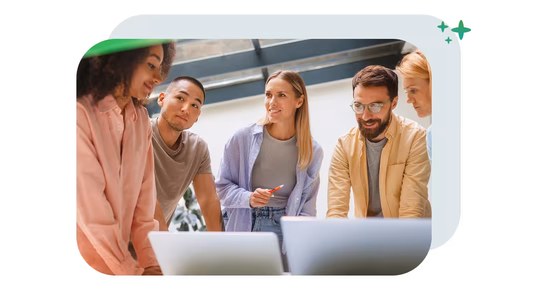 Communications team collaborating around laptops to build an AI-powered content workflow.