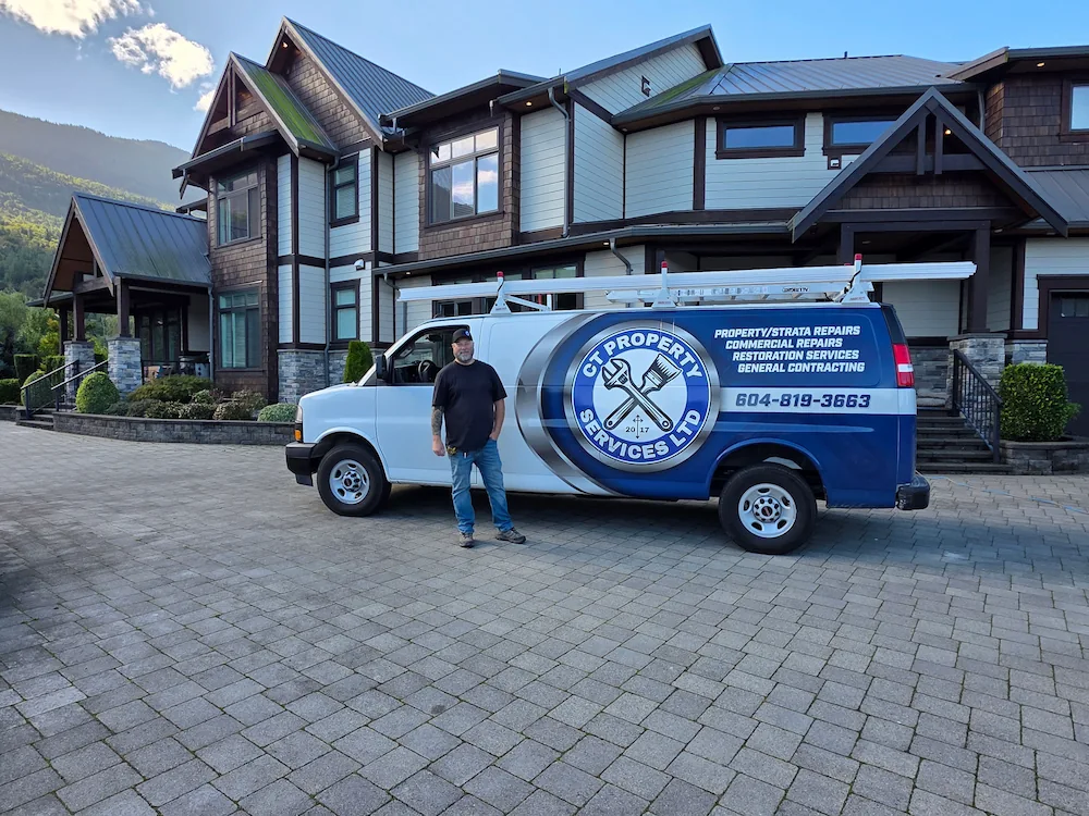 Manager standing beside maintenance van