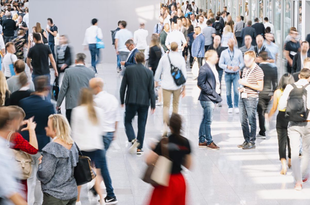 Crowded corridor with blurred people walking in business attire