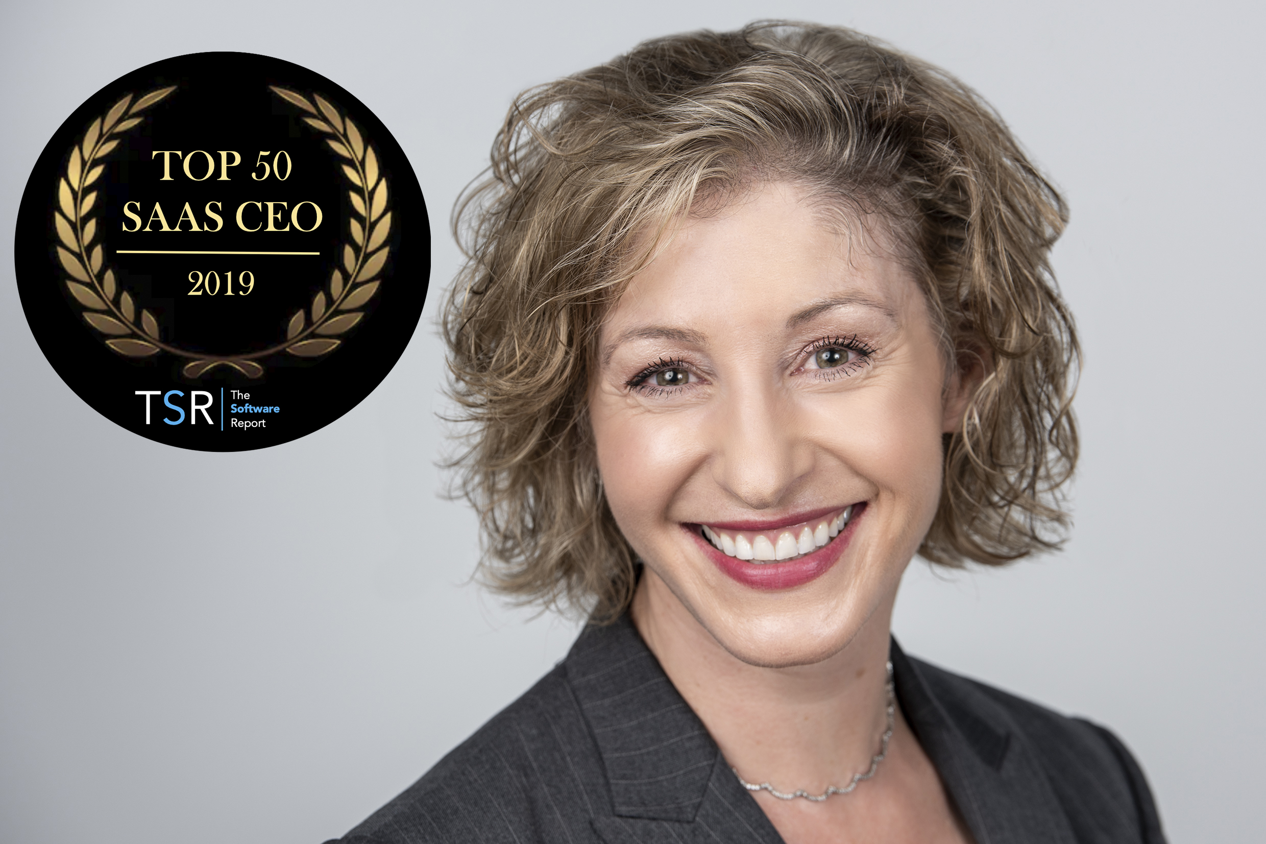 Smiling professional woman with Top 50 SaaS CEO 2019 award badge